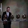 Argentine Lionel Messi poses with his six golden balls during the Ballon d'Or award ceremony in Paris