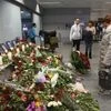 People look at the tributes inside Borispil international airport outside in Kyiv, Ukraine. Photo: AP/PTI