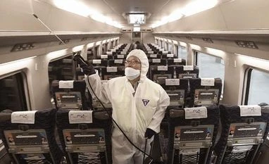 South Korea reports over 300 new Covid-19 cases for second consecutive day Employee disinfecting train in South Korea