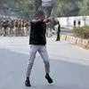 An unidentified man brandishes a gun during a protest against a new citizenship law outside the Jamia Millia Islamia university in New Delhi. Photo: Reuters