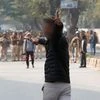 An unidentified man brandishes a gun during a protest against a new citizenship law outside the Jamia Millia Islamia university in New Delhi. Photo: Reuters