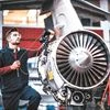 A man fixing an aircraft engine