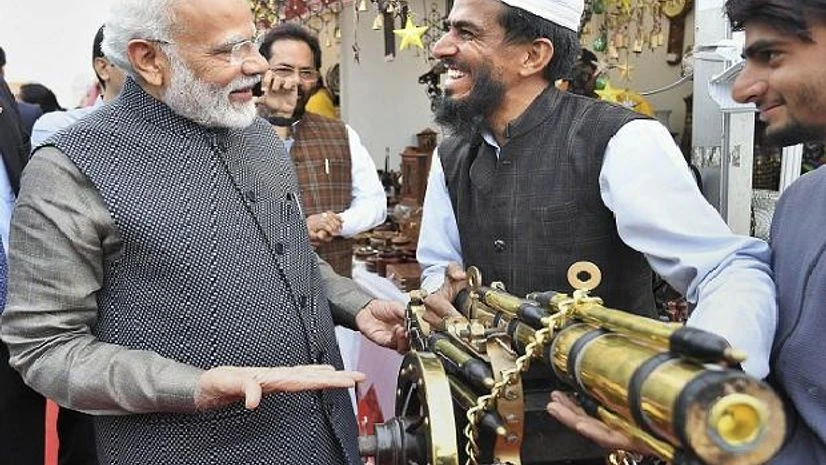 Narendra Modi New Delhi: Prime Minister Narendra Modi interacts with an artisan at 'Hunar Haat' at Rajpath in New Delhi, Wednesday, Feb. 19, 2020 | PTI