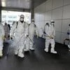 Workers from a disinfection service company seen sanitizing the street in South Korea. Photo: Reuters
