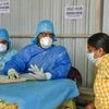 An Indian woman who recently returned from the United States being examined by doctors at a novel coronavirus help desk, at a hospital in Hyderabad