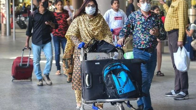 coronavirus Fight passengers, wearing protective masks as precautionary measure against the coronavirus, at the international airport in Mumbai