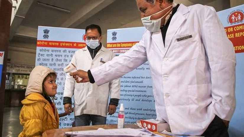 Coronavirus A doctor checks the temperature of a child passenger as part of precautionary measures against the new coronavirus, at a railway station in Jammu | PTI