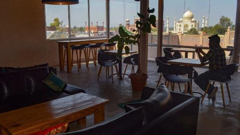 Taj Mahal in Agra A employee of a restaurant sits inside an empty eatery in view of coronavirus pandemic near the historic Taj Mahal in Agra