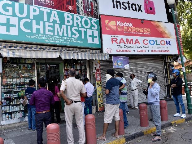 People stand in a queue outside a chemist shop while maintaining social distancing, during the lockdown in Delhi People stand in a queue outside a chemist shop while maintaining social distancing, during the lockdown in Delhi