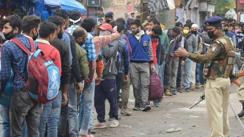 lockdown People stand in a queue at a SRTC bus counter during a 21-day lockdown