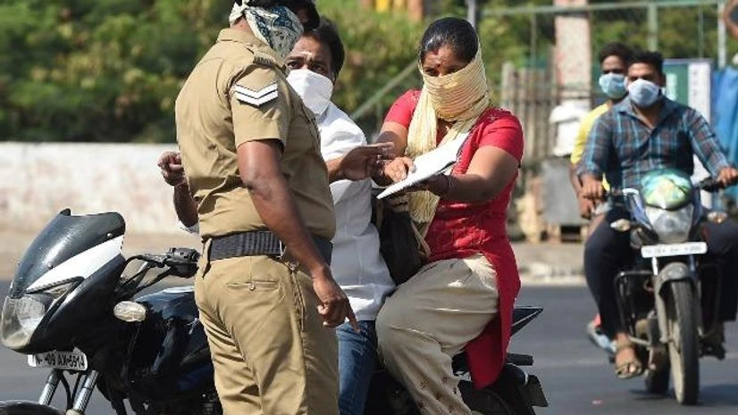 A police personnel verifies documents provided by motorists during a 21-day nationwide lockdown in the wake of coronavirus pandemic, in Chennai A police personnel verifies documents provided by motorists during a 21-day nationwide lockdown in the wake of coronavirus pandemic, in Chennai