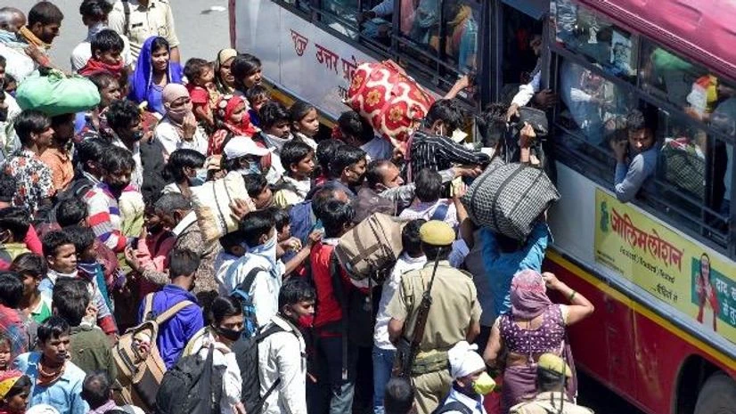 coronavirus, migrant workers Migrants board a bus to their native village, during a nationwide lockdown imposed in the wake of coronavirus pandemic, at Ghazipur Delhi - UP border, Ghaziabad. Photo: PTI