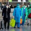 Chinese tourists walk to their gate to catch a flight to China at the airport in Frankfurt, Germany. Photo: PTI