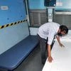 Railway employee prepares a train coach as an isolation ward for the new coronavirus patient, in  Guwahati. Photo: ANI