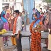 People stand in a queue to buy milk at a shop during a nationwide lockdown in the wake of coronavirus pandemic, in Mathura