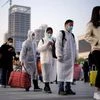 Travellers line up with their belongings outside Hankou Railway Station after travel restrictions to leave Wuhan, the capital of Hubei province and China's epicentre of the novel coronavirus disease (COVID-19) outbreak, were lifted. Photo: Reuters