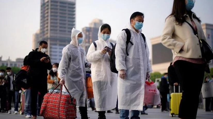 coronavirus, China Travellers line up with their belongings outside Hankou Railway Station after travel restrictions to leave Wuhan, the capital of Hubei province and China's epicentre of the novel coronavirus disease (COVID-19) outbreak, were lifted. Photo: Reuters
