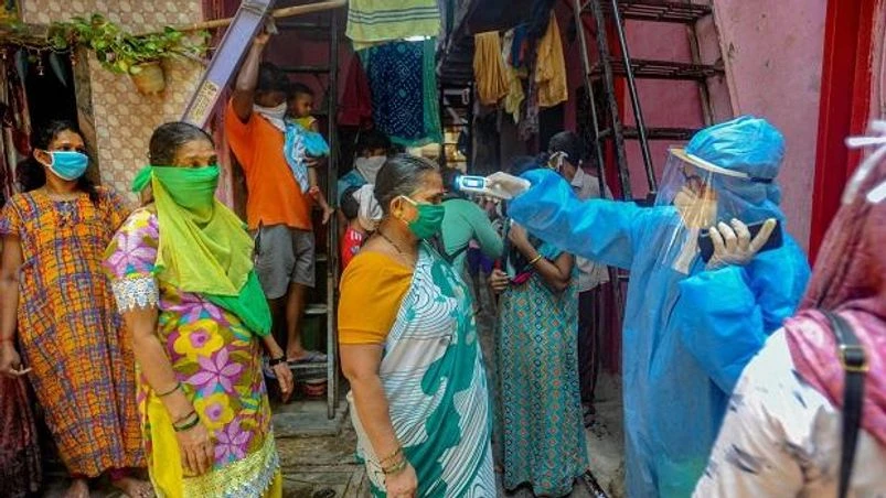 coronavirus, Dharavi Mahim Dharavi Medical Practitioners Association conducts a thermal screening of residents of Shastri Nagar during a nationwide lockdown in the wake of coronavirus pandemic at Dharavi. Photo: PTI