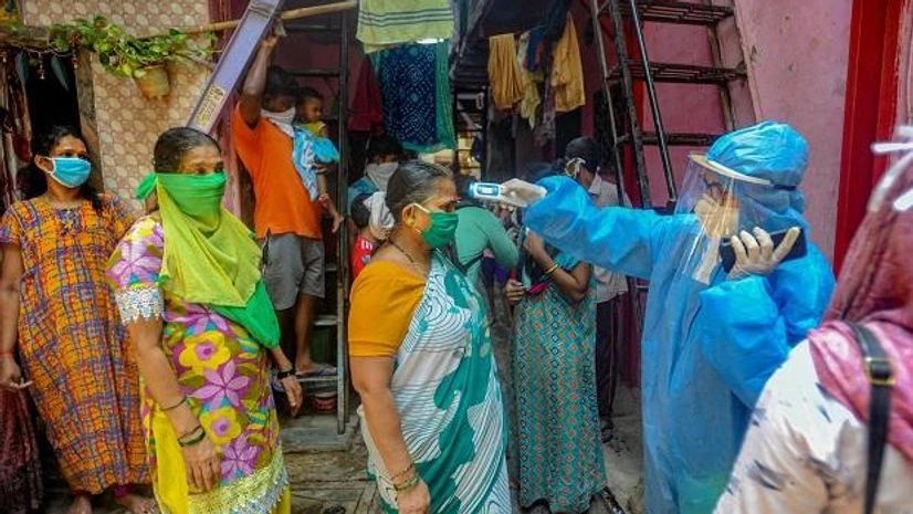 coronavirus, Dharavi Mahim Dharavi Medical Practitioners Association conducts a thermal screening of residents of Shastri Nagar during a nationwide lockdown in the wake of coronavirus pandemic at Dharavi. Photo: PTI