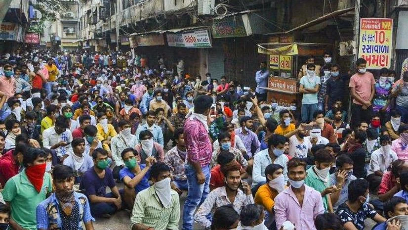 Coronavirus, lockdown, Surat, police, migrants Police stops migrant workers gathered in large number demanding to go back to their native places after the announcement of nationwide lockdown got extended. Photo: PTI