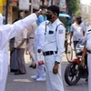 Thermal screening of security personnel being conducted during a nationwide lockdown in the wake of coronavirus pandemic, in Howrah. Photo: PTI