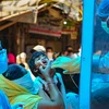 Medics wearing protective suits collect swab sample of Chandni Mahal residents, after the area was identified as COVID-19 hotspot, during the nationwide lockdown, in New Delhi. Photo: PTI