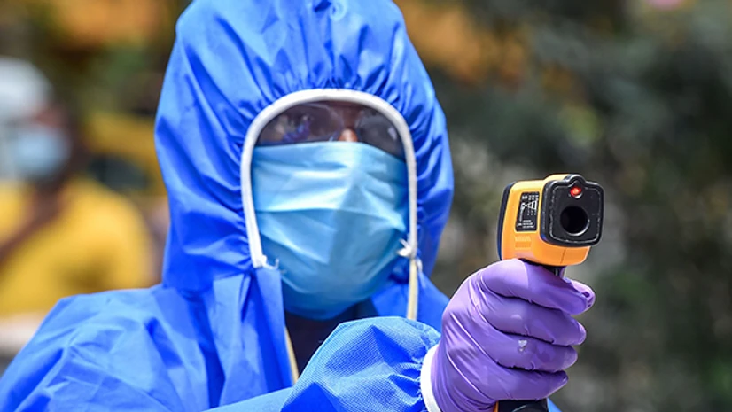 thermal screening, coronavirus, Coronavirus screening A health-worker conducts thermal screening of residents in the Mudiali area which was sealed following detection of a COVID-19 positive case, during ongoing nationwide lockdown to contain the pandemic