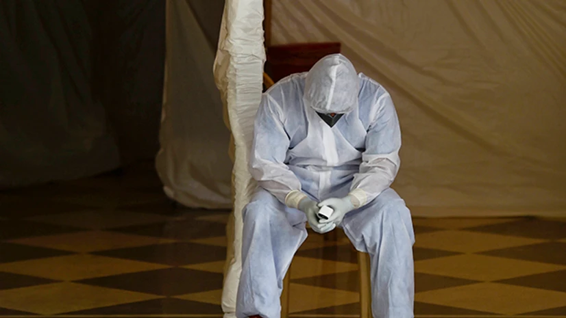 coronavirus, doctors, medicos A health worker in protective gear waits for samples from people for COVID -19 tests, in New Delhi. Photo: PTI
