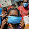Slum dwellers, oblivious of social distancing guidelines, queue up to receive face masks from the members of the National Human Rights and Crime Control Organization during ongoing COVID-19 lockdown, in Amritsar. Photo: PTI