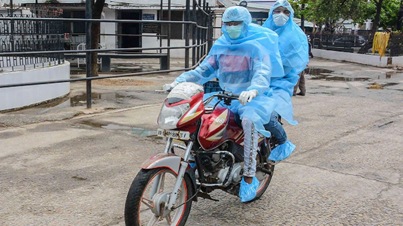 Patna, lockdown, coronavirus, bihar, covid 19 Patna: Medics wearing protective suits are seen riding a bike, during a nationwide lockdown to curb the spread of coronavirus, in Patna, Sunday, April 26, 2020. (PTI Photo)(