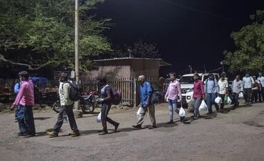 lockdown, coronavirus, Migrant workers Migrants from various northern states of India walk to board a special train for Gorakhpur, during the ongoing COVID-19 lockdown, in Bhiwandi