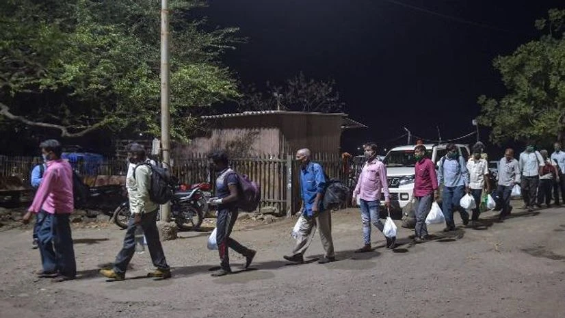 lockdown, coronavirus, Migrant workers Migrants from various northern states of India walk to board a special train for Gorakhpur, during the ongoing COVID-19 lockdown, in Bhiwandi