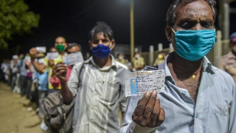 lockdown, coronavirus, Migrant workers Migrants from various northern states of India wait to board a special train for Gorakhpur, during the ongoing COVID-19 lockdown, in Bhiwandi