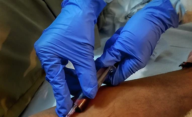 Clinical trial begins to assess plasma efficacy to limit Covid-19: ICMR A medic provides medicine as part of Covid-19 treatment at Sri H. N. Reliance Foundation Hospital in collaboration with the Brihanmumbai Municipal Corporation (BMC), in Mumbai. Photo: PTI