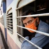 A migrant wearing a protective mask boards a train to Jharkhand, during the nationwide lockdown, in Jalandhar. Photo: PTI