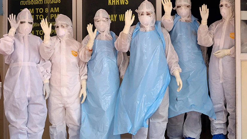 Lockdown 3.0, coronavirus, Covid-19, hospital, medics, doctor Medics wave at a Covid-19 patient who was being discharged as the last patient recovered at Kozhikode Medical College, in Kozhikode. Photo: PTI