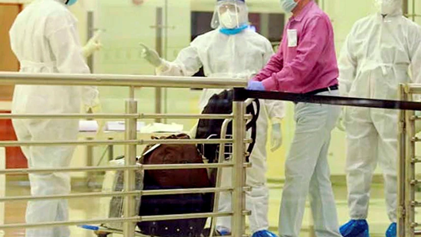 Medics screen a passenger after an Air India Express flight brought stranded Indian nationals from Abu Dhabi, UAE, as part of the repatriation exercise ‘Vande Bharat Mission’, at the airport in Kochi. Photo: PTI Medics screen a passenger after an Air India Express flight brought stranded Indian nationals from Abu Dhabi, UAE, as part of the repatriation exercise ‘Vande Bharat Mission’, at the airport in Kochi. Photo: PTI