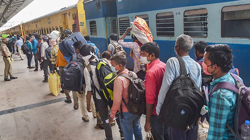 migrant workers, lockdown 3.0, Covid-19, Coronavirus, labourers, Indian Railways Migrants flout social distancing norms as they gather outside a registration camp to travel back to their native places, during the ongoing COVID-19 nationwide lockdown, in Jalandhar. Photo: PTI