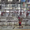 A worker cleans Howrah station before the arrival of  'Shramik Special' train transporting migrants from various parts of the country, during the ongoing Covid-19 nationwide lockdown, in Kolkata. Photo: PTI