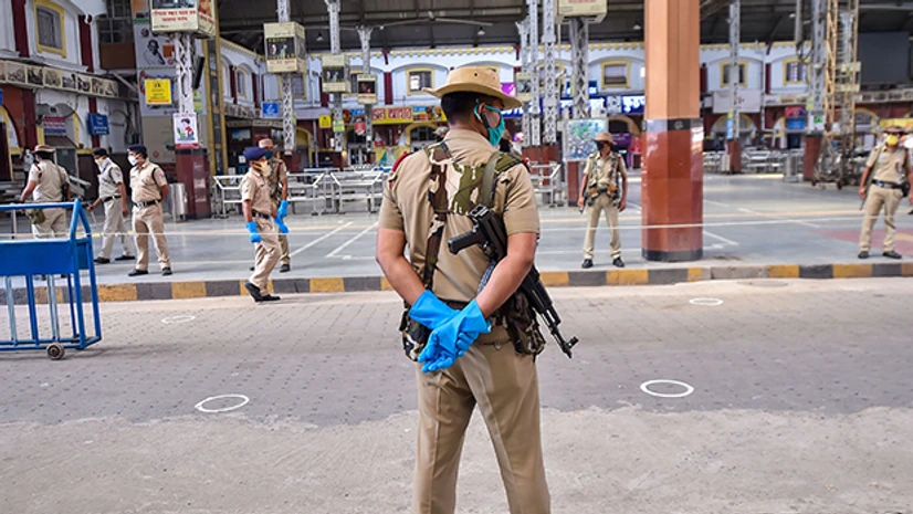 Shramik train, Howrah Station, Kolkata railway station, Indian Railways Security personnel stand guard as they wait for the arrival of 'Shramik Special' train transporting migrants from various parts of the country, during the ongoing Covid-19 nationwide lockdown, at Howrah station in Kolkata. Photo: PTI