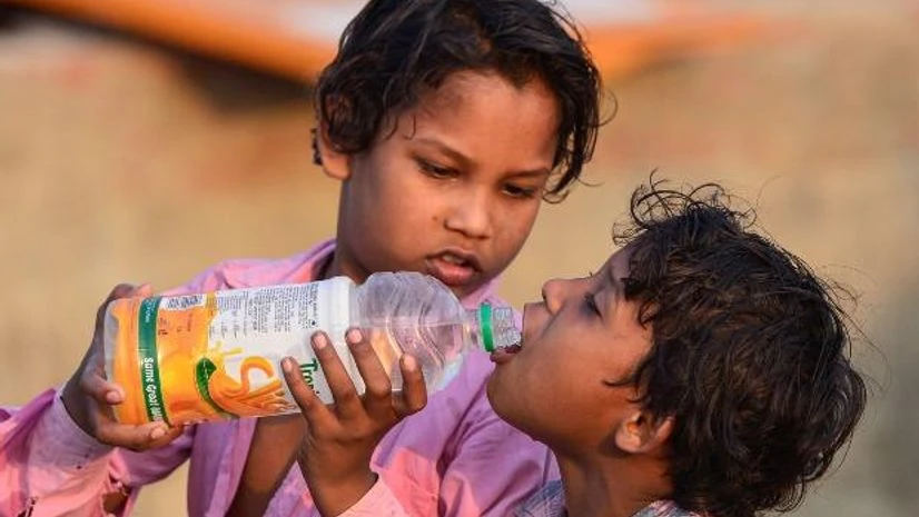 Migrant children Migrant children quench their thirst during their journey towards their native place in Uttar Pradesh, amid ongoing COVID-19 lockdown, in Ghaziabad