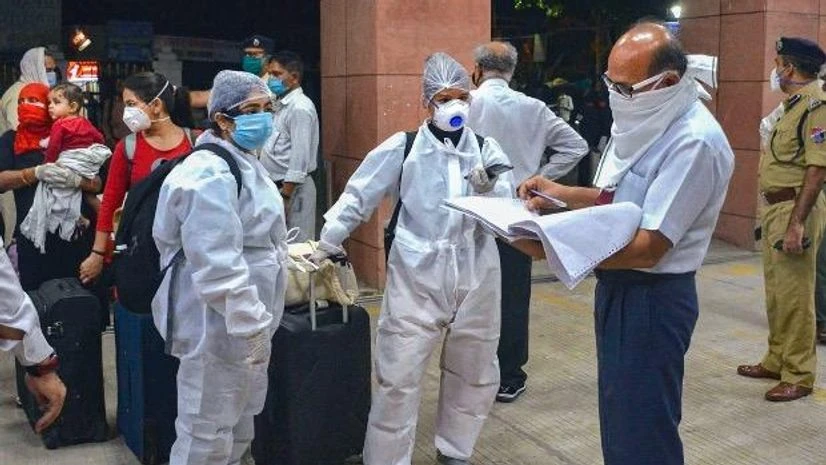 Indian railways, Covid-19, coronavirus, passengers, checking A railway official checks documents of passengers before boarding a train at a railway station following the resumption of passenger train services by the Indian Railways in a graded manner, in Bhopal. Photo: PTI