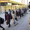 Migrants with their belongings arrive from Mumbai via special train at Prayagraj railway station, during the ongoing COVID-19 nationwide lockdown, in Prayagraj