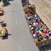 Migrants travel on a lorry to return to their hometowns, during ongoing Covid-19 lockdown in Mathura. Photo: PTI
