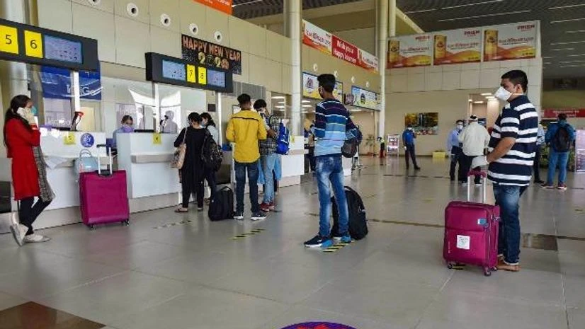flights, airport Passengers respecting social distancing norms stand outside a counter at the Prayagraj Airport, following the resumption of domestic flights