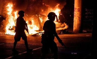 George Floyd, US violence Police stand guard as Austin Fire Department put out a car fire under Interstate 35 freeway in Austin Texas