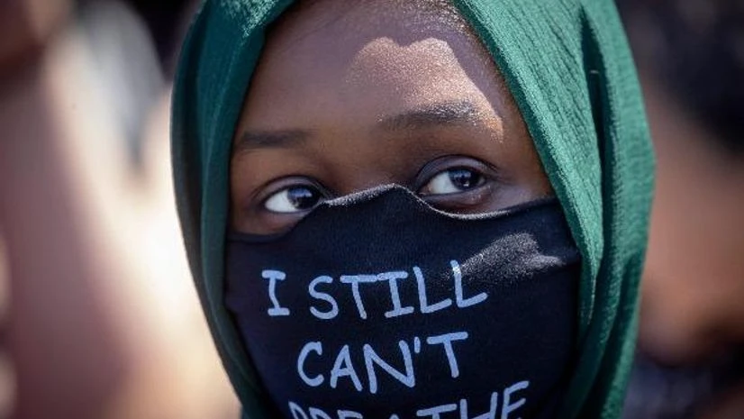 George Floyd, US Violence A person wears a mask with a message at the Minneapolis corner where George Floyd was restrained by Minneapolis police