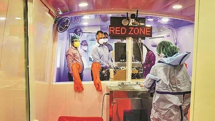 Medical workers in protective gear at a mobile coronavirus testing facility, in New Delhi on Monday. Photo: PTI Medical workers, protective gear, mobile coronavirus testing facility, ppe