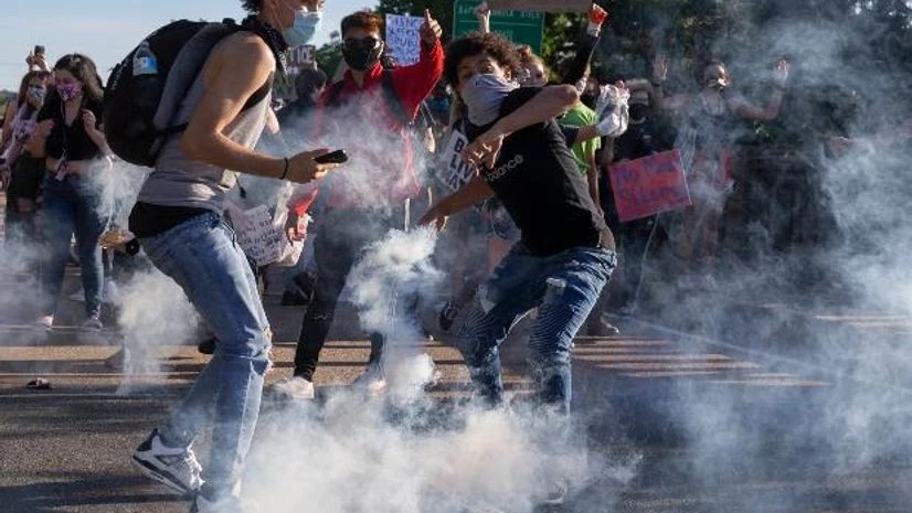 Protesters throw a tear gas canister back toward Stafford County deputies on the Falmouth Bridge in Fredericksburg Protesters throw a tear gas canister back toward Stafford County deputies on the Falmouth Bridge in Fredericksburg
