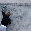 A person cleans graffitis from the statue of Winston Churchill at Parliament Square, in the aftermath of protests against the death of George Floyd in Minneapolis police custody, in London, Britain
